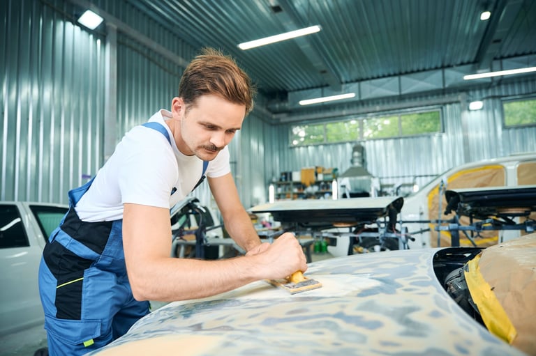 Male worker working with a grinding tool in workshop